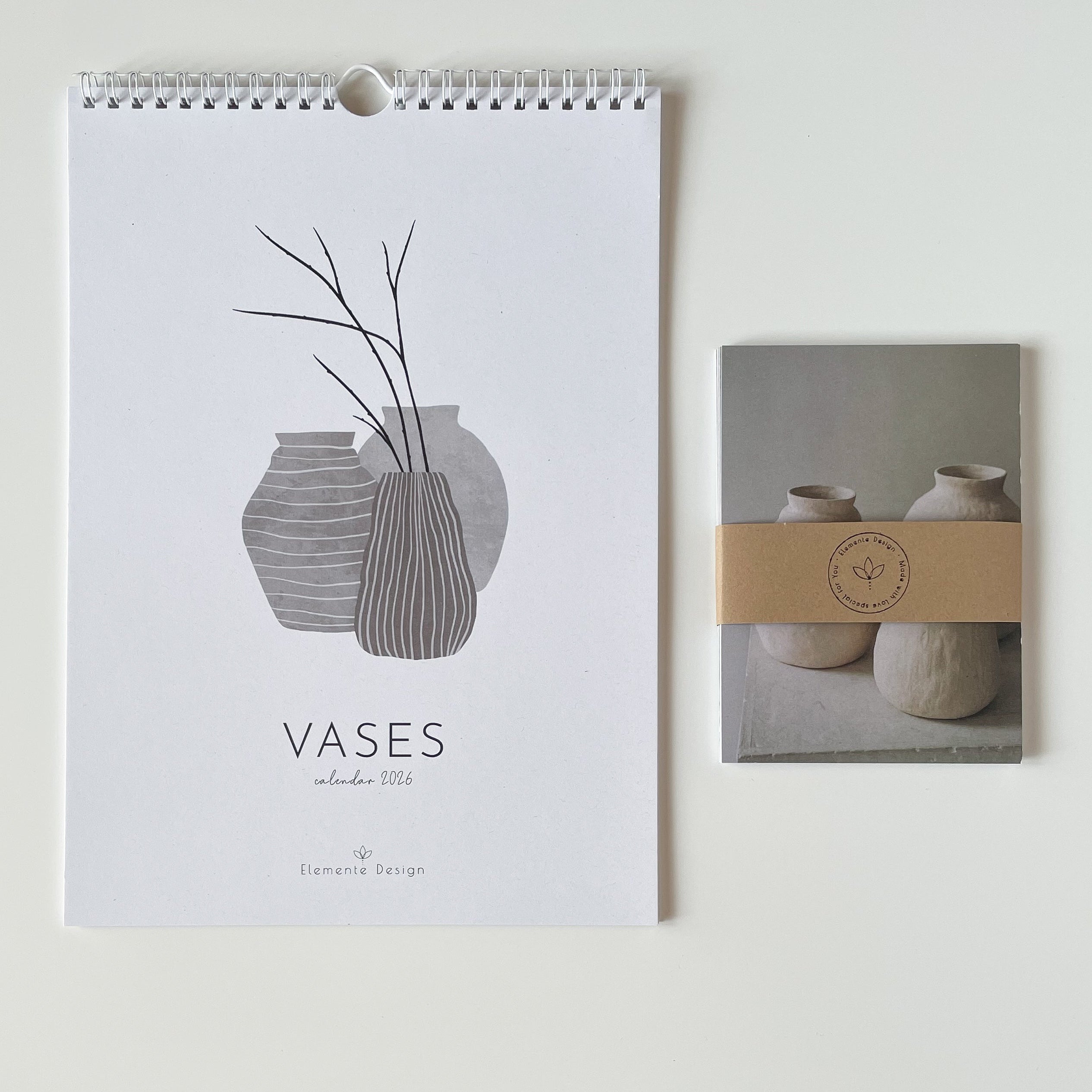 Wall calendar with vase design and a set of photo postacrds on a white background