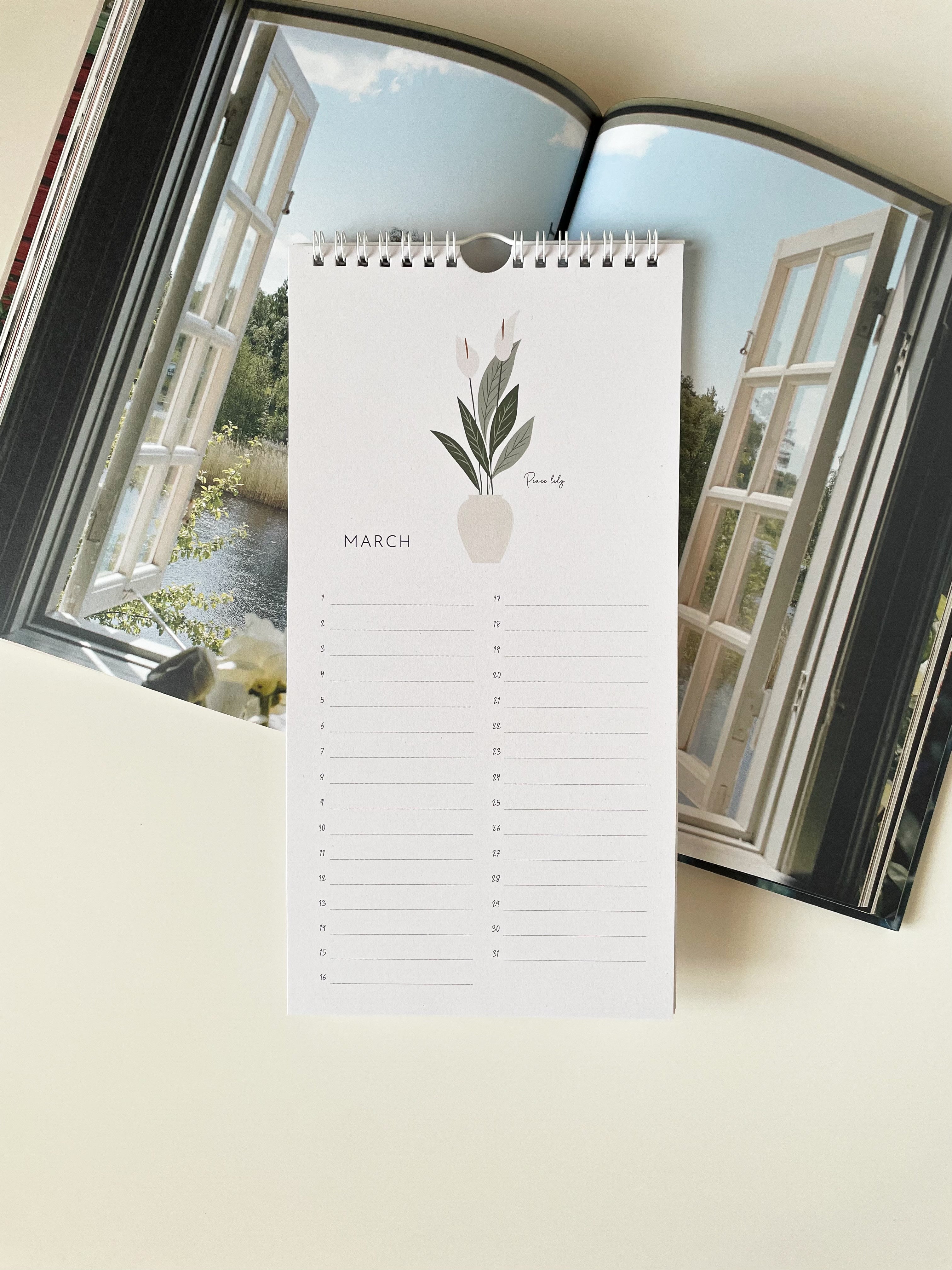 perpetual calendar with floral design on a window background