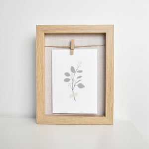 taped eucalyptus greeting card in frame Elemente Design